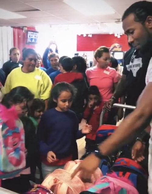 Josh gives out backpacks to children released from detention centers